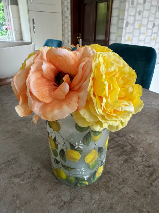 Lemon vase with yellow and peach bouquet