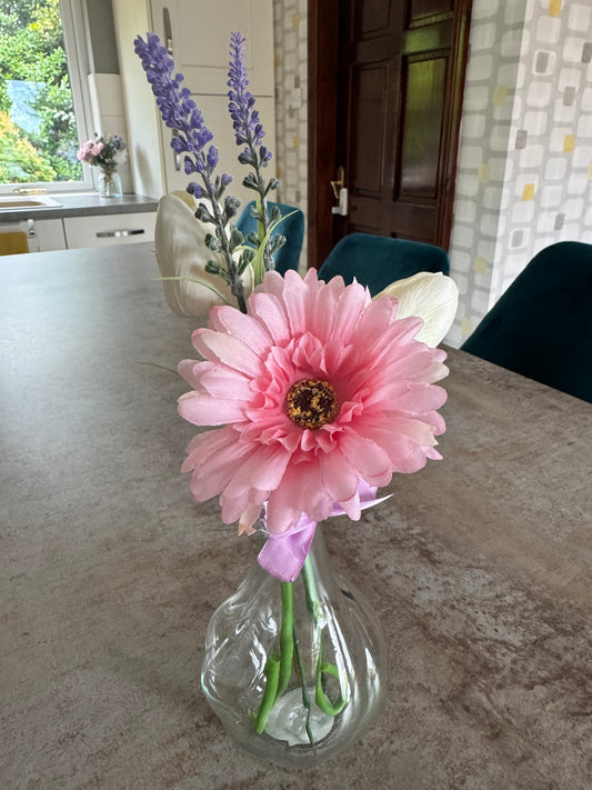 Stunning pink daisy and white tulips finished with a purple bow