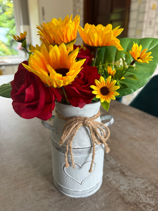 Sunflowers and red roses in a beautiful vintage style heart vase