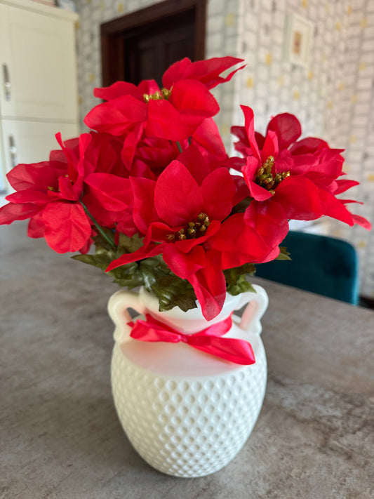 White vase with beautiful red flowers perfect for Christmas