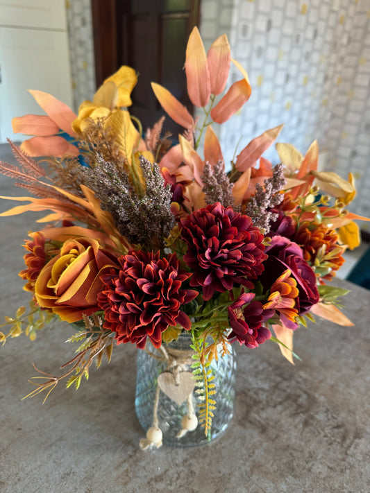 Autumnal colours in a beautiful glass vase with heart ribbon