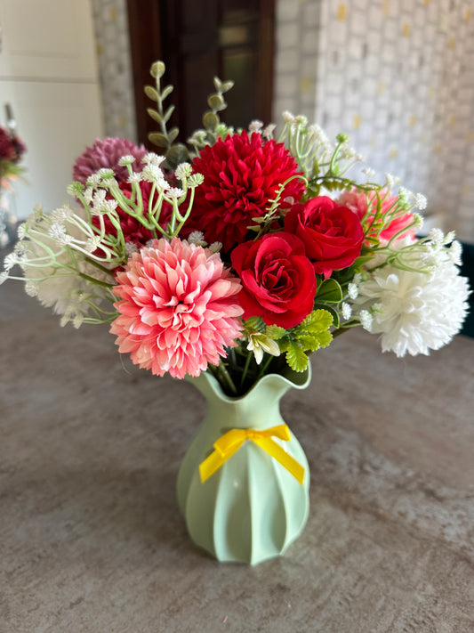 Colourful arrangement in a plastic lime green vase with yellow bow